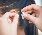 Closeup, hands and hearing aid support for a person, listening help and medical gear. Healthcare, deaf and a woman with an implant for audio health, medical innovation and device for sound waves