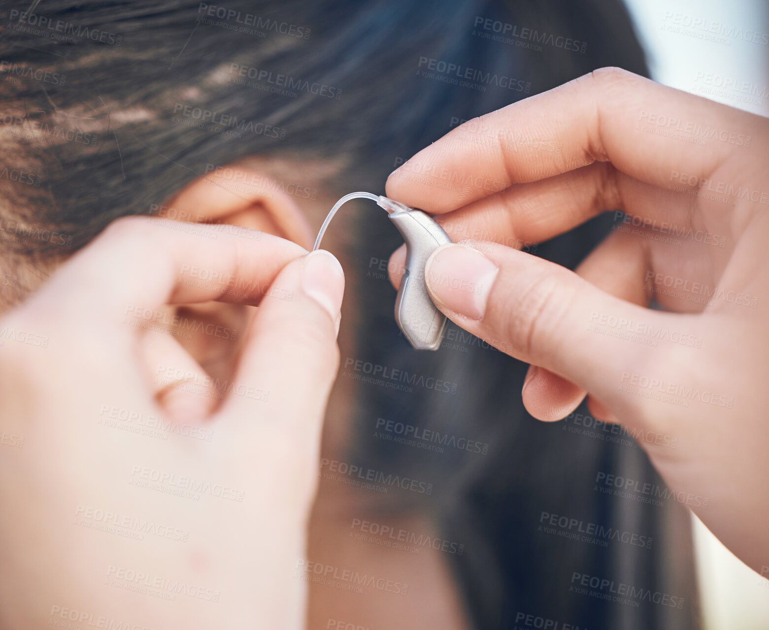 Buy stock photo Closeup, hands and hearing aid support for person, listening help and medical gear. Healthcare, woman with a disability and audio health, clinic innovation and device for sound waves or communication