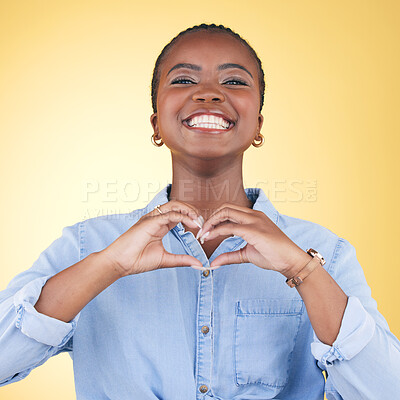 Buy stock photo Black woman, heart hands and health with emoji, smile in portrait and love isolated on yellow background. Support, care and kindness with respect, happiness and wellness, romance sign in a studio