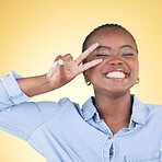 Hands, peace sign and face of black woman in studio smile for confidence, glow and beauty. Emoji, hand gesture and African person on yellow background with cosmetics, makeup and glamour and sign
