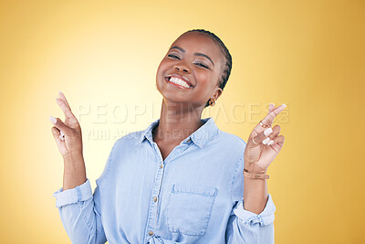 Buy stock photo African woman, cross fingers and studio portrait for luck, excited smile or trendy clothes by yellow background. Young fashion model, happy student or sign language for hope, wish or dream of success