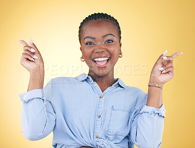 Buy stock photo Portrait, dance and celebration with an excited black woman on a yellow background in studio looking happy. Smile, energy or surprise and a young person cheering for success or bonus with motivation