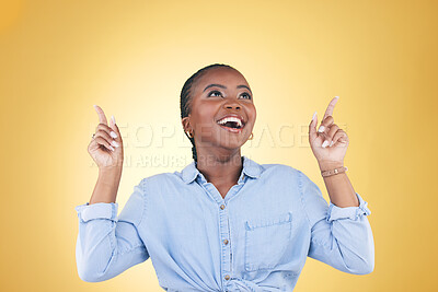 Buy stock photo Black woman, excited and surprise, pointing up and advertising with presentation news isolated on yellow background. Announcement, opportunity and offer with wow, communication and ads in studio