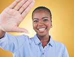 Selfie, smile and portrait of black woman in studio for motivation, social media and influencer. Happy, freedom and profile picture with face of person on yellow background for post and happiness