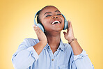 Black woman, happiness and headphones with music, energy and audio streaming isolated on yellow background. Sound, entertainment and radio with freedom, person with fun and technology in a studio