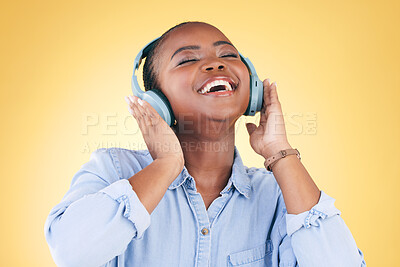 Buy stock photo Black woman, happiness and headphones with music, energy and audio streaming isolated on yellow background. Sound, entertainment and radio with freedom, person with fun and technology in a studio