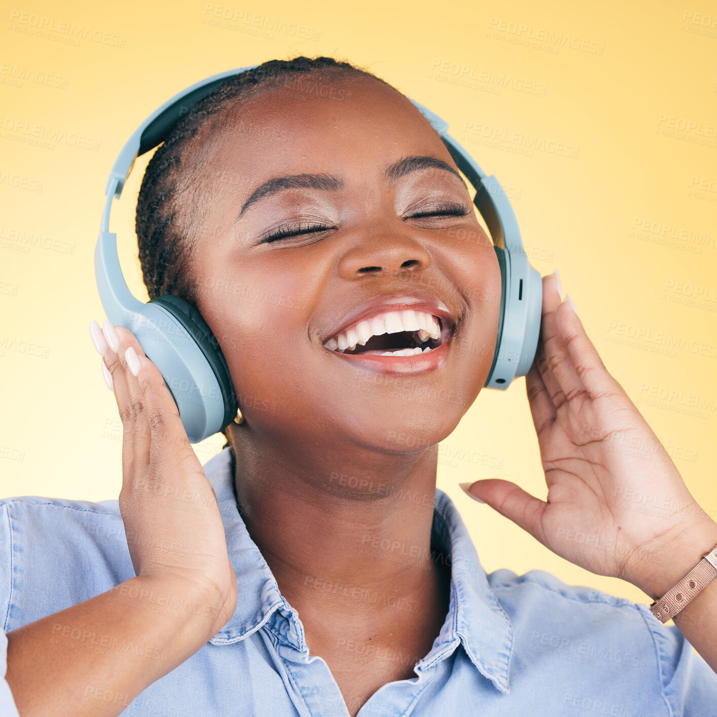 Buy stock photo Singing, music and black woman on headphones, smile and listening in studio isolated on a yellow background. Happy, radio and African person streaming podcast, audio and sound, hearing and freedom.