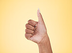 Woman, hands and thumbs up in winning, success or approval against a studio background. Closeup of female person with like emoji, yes sign or okay in thank you, agreement or finger gesture on mockup