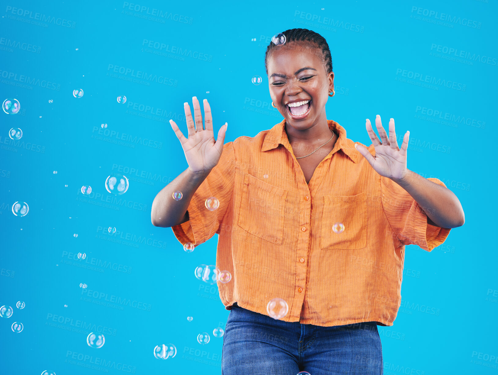 Buy stock photo Excited, laugh and black woman on blue background with bubbles for happiness, joy and have fun. Playful, happy smile and isolated African person in studio with soap bubble for freedom and color