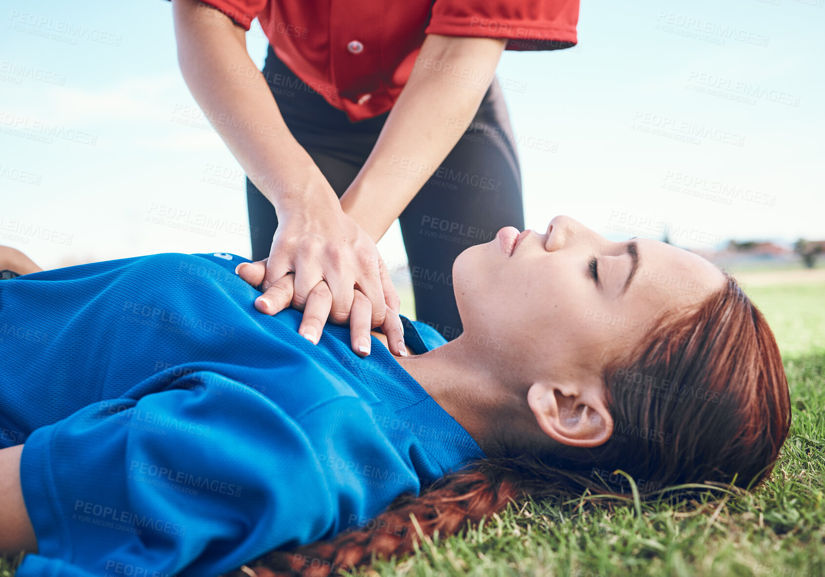 Buy stock photo Cpr, outdoor and hands on chest, women and help on a field, resuscitation and medical emergency. Closeup, player outside and heart attack with volunteer, accident and first aid to rescue a person