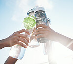 Hands, water bottle and toast to fitness together after workout, exercise or training outdoor with team of players. Sport, goals and cheers with group and liquid for hydration, celebration and unity