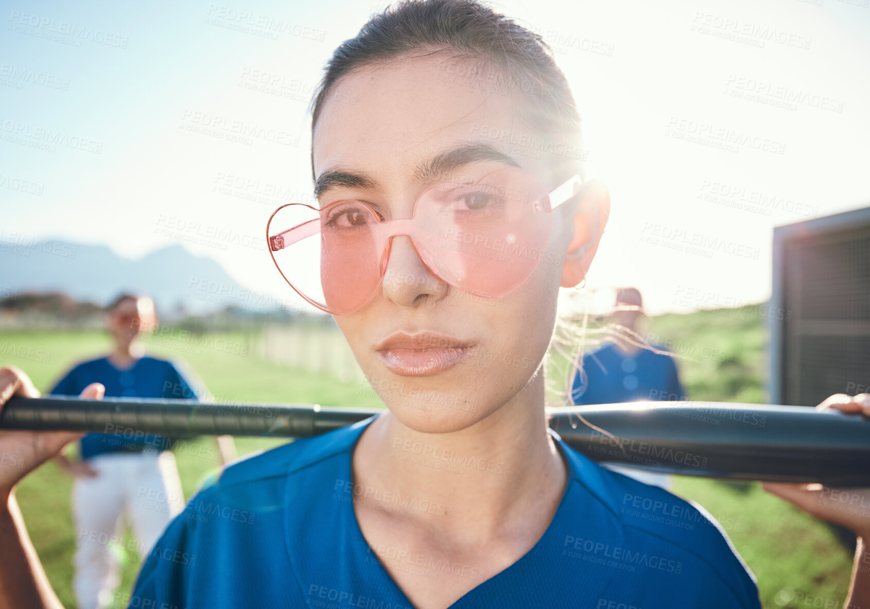 Buy stock photo Baseball player, sunglasses and a sports person with bat outdoor on pitch for performance at competition. Face of athlete or softball woman for portrait, commitment or fitness for game or training
