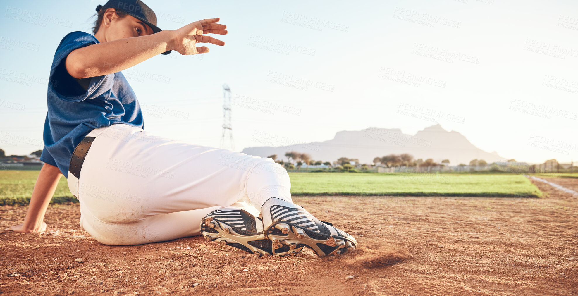 Buy stock photo Slide, baseball action and player in dirt for game or sports competition on a pitch in a stadium. Man, ground and  tournament performance by athlete or base runner in training, exercise or workout