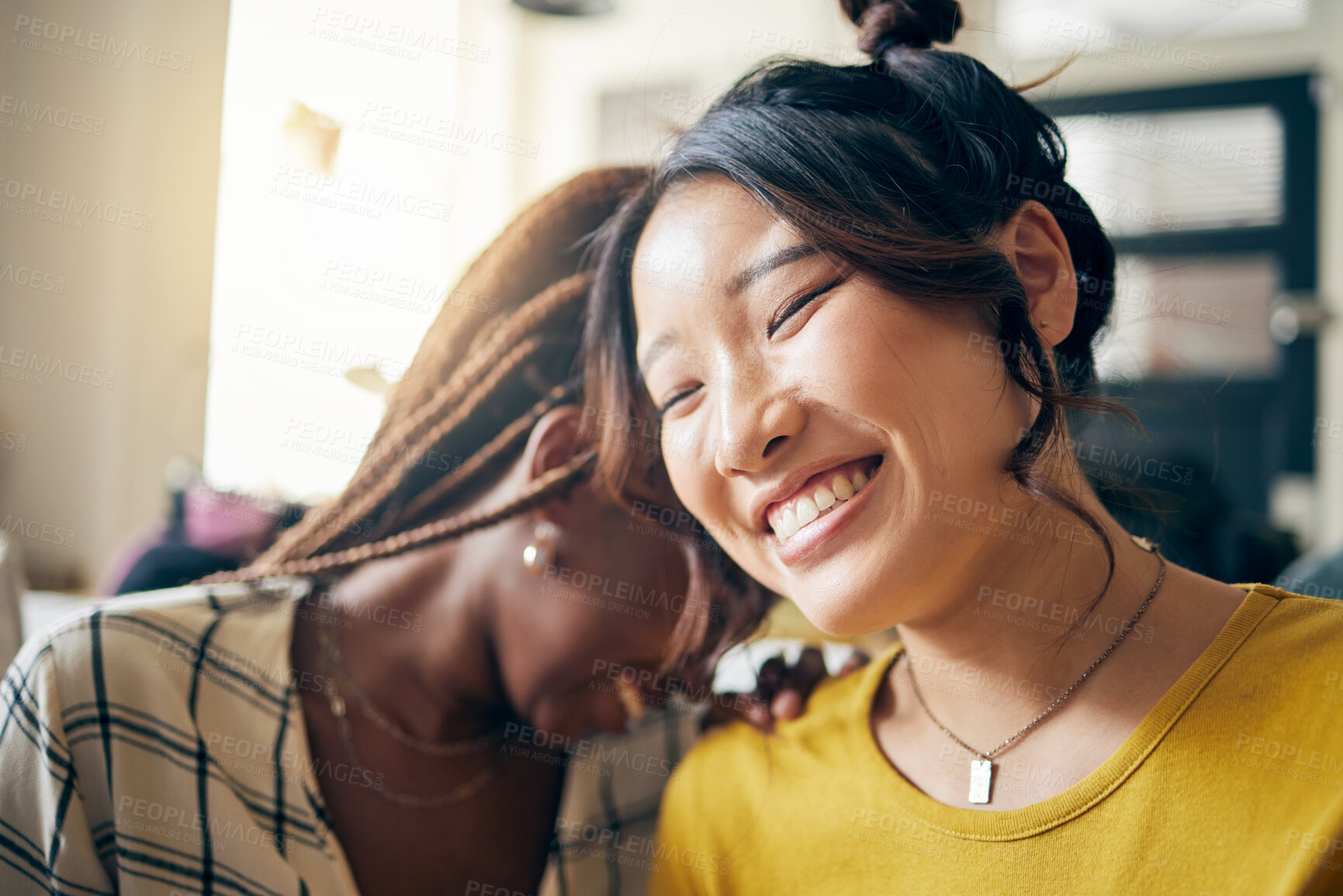Buy stock photo Happy, laughing and lesbian couple talking at their home with a funny or comedy joke. Happiness, love and interracial lgbtq women with a smile for bonding in the living room of their modern apartment