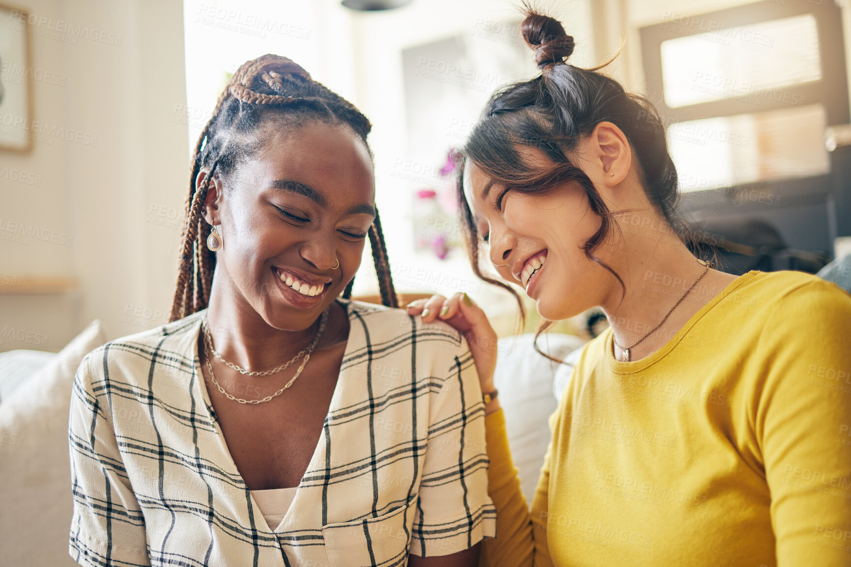 Buy stock photo Happy, funny and friends gossip, speaking and bond with joke, humor and story in their home. Smile, laugh and women with diversity in a living room share drama, chat and silly, talk and enjoy weekend