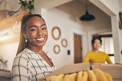 Buy stock photo Black woman, portrait and new home with cardboard boxes for moving and property investment. Happy face, smile and couple of friends excited with package for real estate in a living room together 