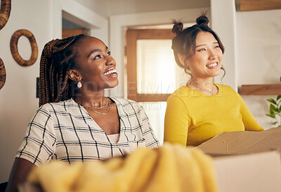 Buy stock photo Happy, smile and lesbian couple moving in their new home with cardboard boxes together in living room. Happiness, love and interracial lgbtq women homeowners in the lounge of their modern apartment.