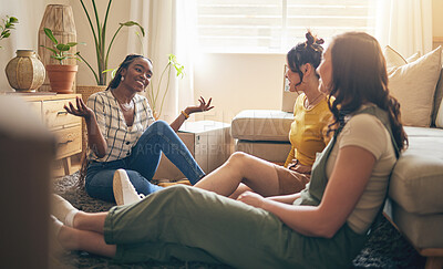 Buy stock photo Happy, gossip and friends on a floor relax, talking and bond with advice in house together. Conversation, drama and women with diversity in a living room speaking, chilling and enjoy weekend freedom