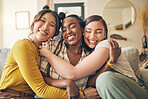 Portrait of a group of women, friends on sofa with smile and bonding in living room together in embrace. Hug, love and friendship, girls on couch with diversity, pride and people in home with fun.