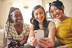Young women, comedy online and smartphone, friends relax at home with social media and communication. Gen z, happiness and funny meme, chat and using phone with people on couch, mobile app and tech