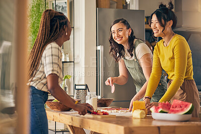 Buy stock photo Friends, smile and women cooking pizza in kitchen, bonding and having fun together in home. Happy, girls and baking food, margherita and salami bread at lunch, cheese on meat and brunch in house