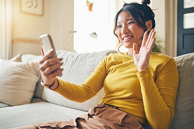 Buy stock photo Phone, wave and Asian woman on video call on sofa, communication and conversation in living room. Smartphone, hello and happy person in webinar, virtual chat and online meeting in house discussion