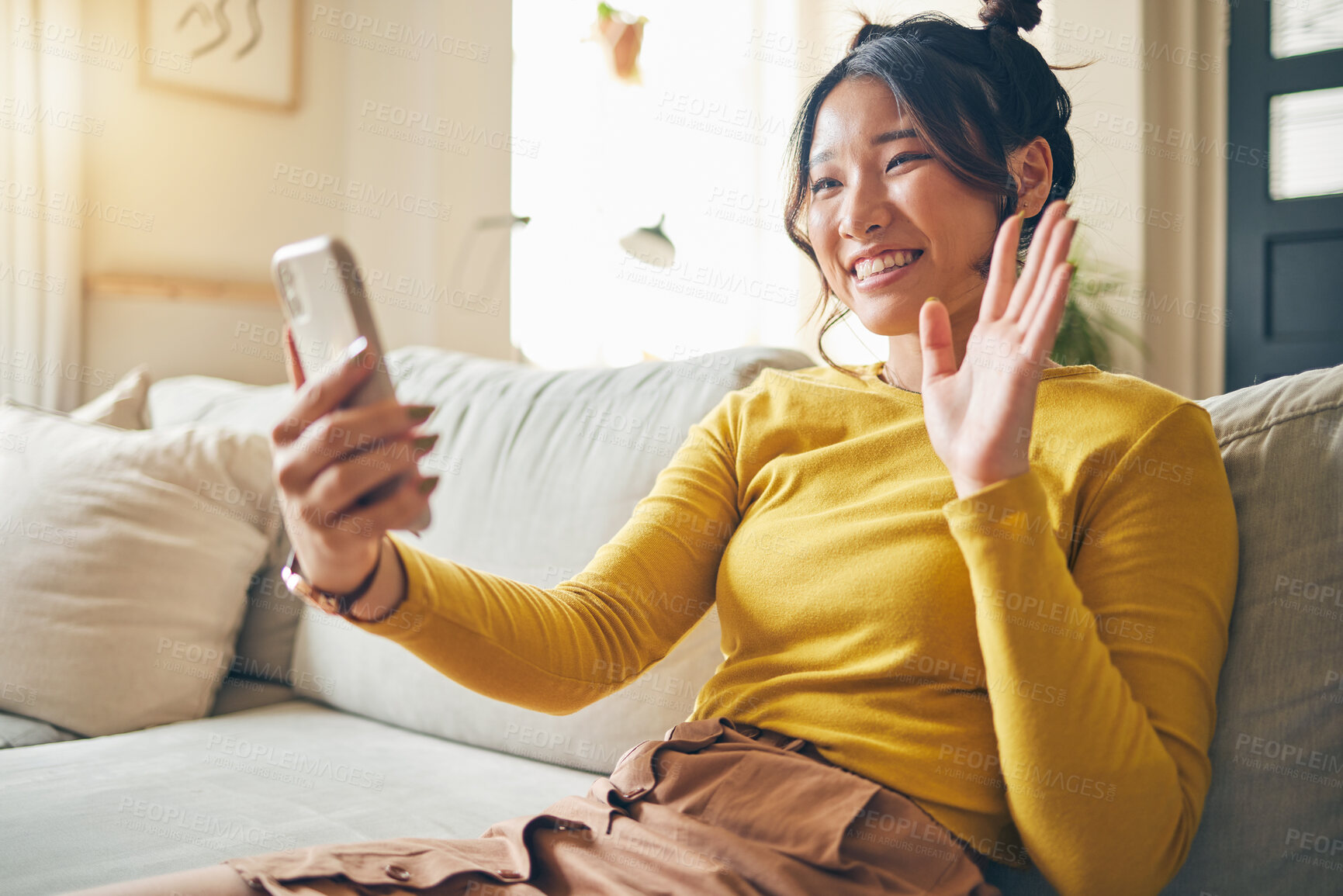 Buy stock photo Phone, wave and Asian woman on video call on sofa, communication and conversation in living room. Smartphone, hello and happy person in webinar, virtual chat and online meeting in house discussion