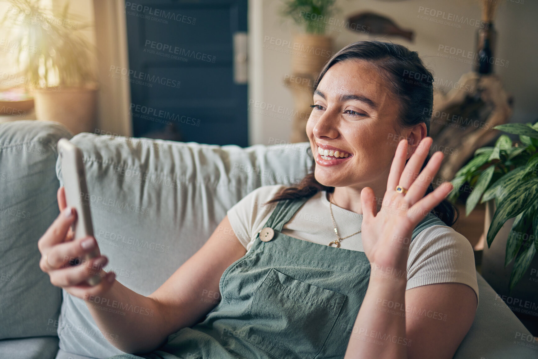 Buy stock photo Phone, wave and woman on video call in home, communication and conversation on sofa. Smartphone, hello and happy person in webinar, virtual chat and online meeting, welcome and greeting in house.