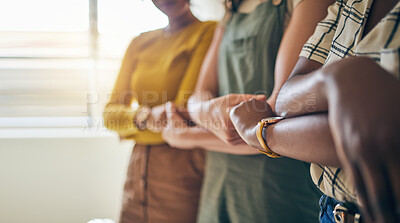 Buy stock photo Holding hands, arms crossed and unity with business women in a row for equality or empowerment. Support, teamwork or collaboration with a creative employee group in the office for partnership closeup