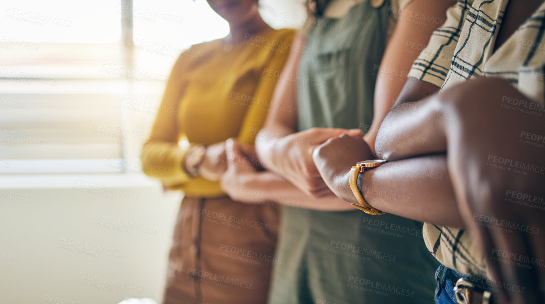 Buy stock photo Holding hands, arms crossed and unity with business women in a row for equality or empowerment. Support, teamwork or collaboration with a creative employee group in the office for partnership closeup