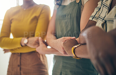 Buy stock photo Holding hands, arms crossed and support with business women in a row for equality or empowerment. Unity, teamwork or collaboration with a creative employee group in the office for partnership closeup