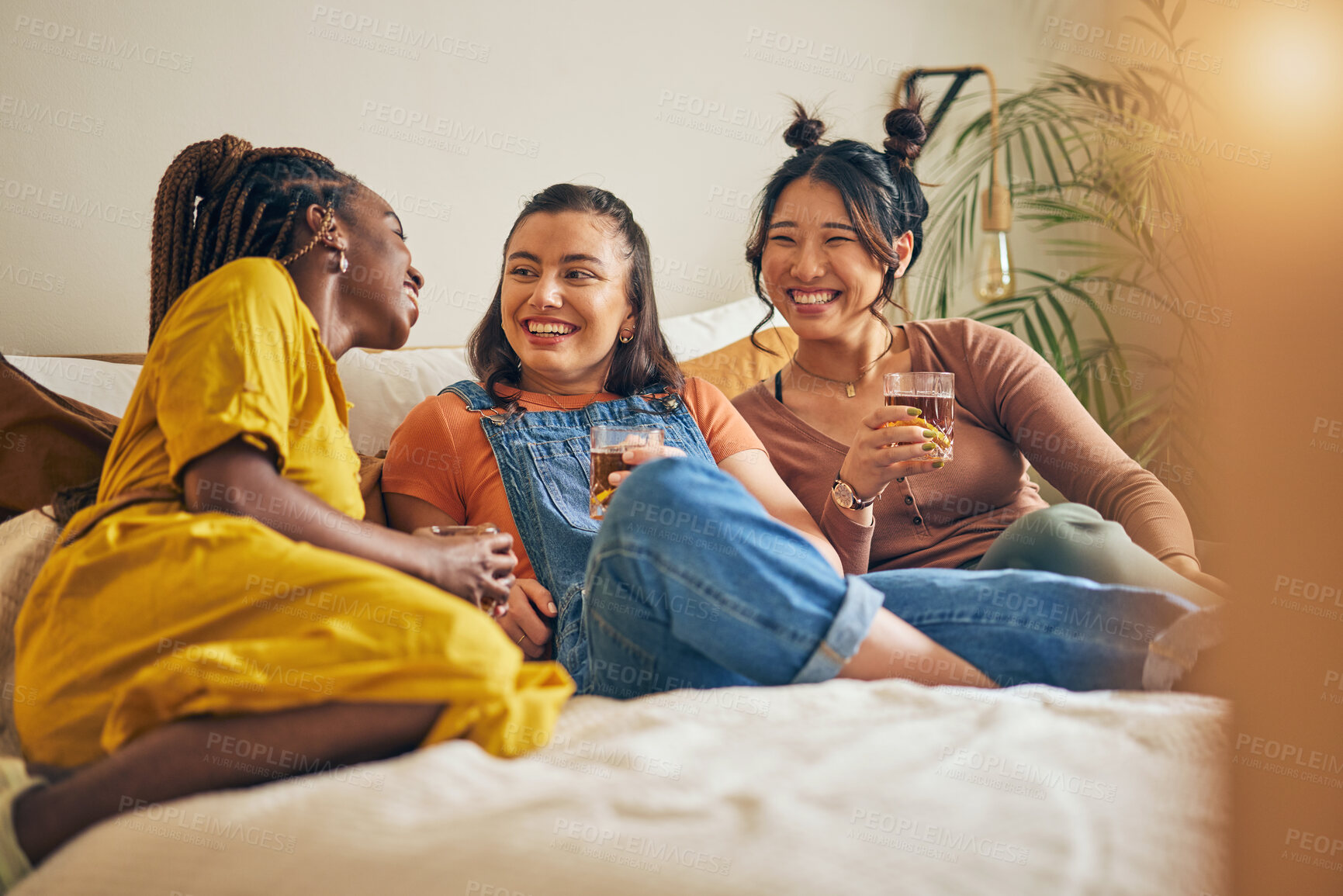 Buy stock photo Friends, conversation and women with drink in home for relaxing, bonding and talking together. Friendship, happy and group of people laughing for relationship, visit and chat on sofa in living room