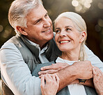 Happy, love and senior couple hug at a park, free and enjoy travel, holiday or weekend. Face, smile and elderly man embrace woman in forest, bond and having fun on retirement trip outdoor together