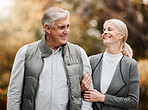 Happy, love and peace with old couple in nature for bonding, relax and support. Smile, happiness and retirement with senior man and woman walking in countryside park for vacation and commitment 