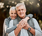 Happy, portrait and senior couple hug at a park, free and enjoy travel, holiday or weekend outdoor. Face, smile and elderly woman embrace man in forest, bond or having fun on retirement trip together