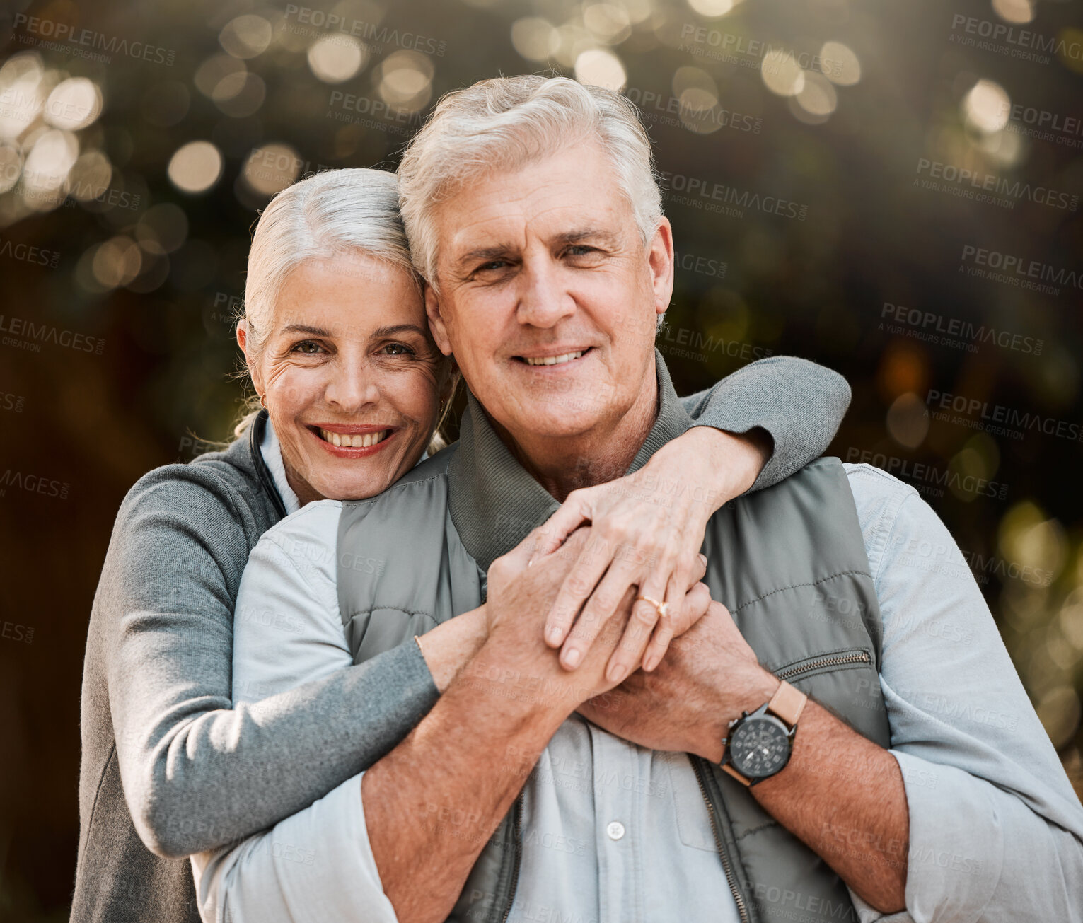 Buy stock photo Happy, portrait and senior couple hug at a park, free and enjoy travel, holiday or weekend outdoor. Face, smile and elderly woman embrace man in forest, bond or having fun on retirement trip together