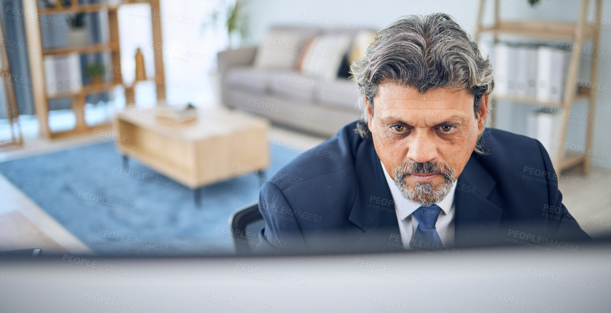 Buy stock photo Mature businessman, reading and computer in home, apartment or corporate employee with remote work in lounge. Distance, working and manager with project, report or review on pc in house office