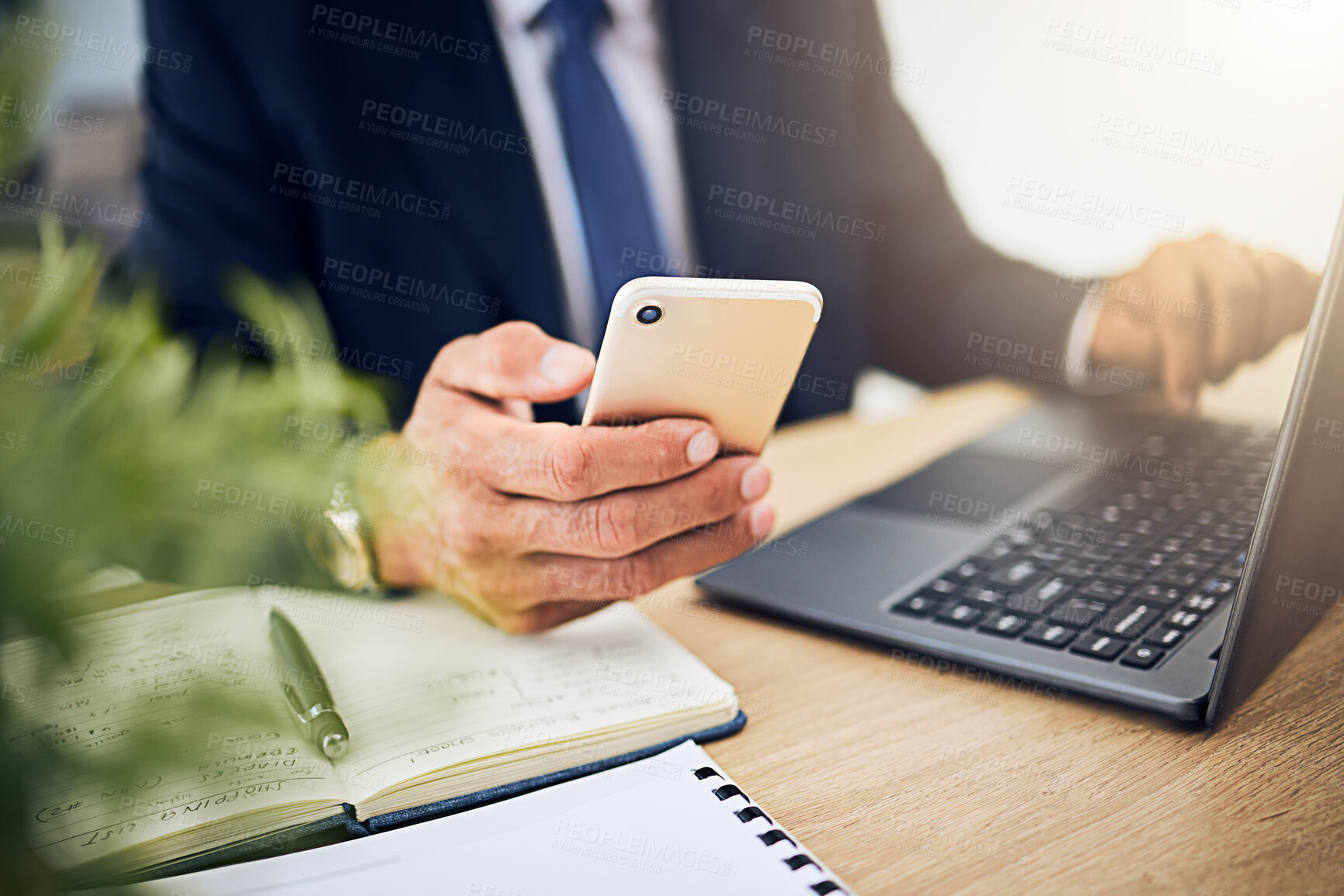Buy stock photo Phone, laptop and a business person with internet for research, information technology or contact. Hands of a professional man with a smartphone and notebook for planning, schedule or communication