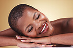 Makeup, face and beauty of happy woman in studio for self care, skin glow or cosmetics. Closeup of African aesthetic model person with facial shine, dermatology or relax on hands on beige background