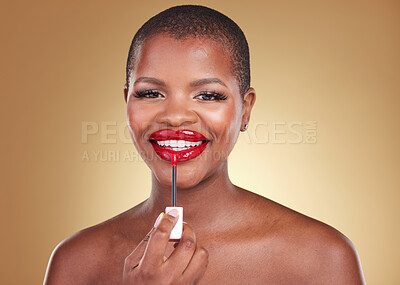 Buy stock photo Beauty, makeup brush and a woman with red lipstick in studio for portrait, glow or cosmetics. Face of happy African person with facial shine, dermatology and application on lips on a beige background