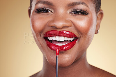 Buy stock photo Makeup brush, beauty and a woman with red lipstick in studio for closeup, glow or cosmetics. Face of happy African person with facial shine, dermatology and application on mouth on a beige background