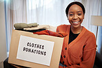 Clothes donation, charity and woman portrait with box for nonprofit and cardboard container at home. African female person, donating and house with giveaway for community support with packing