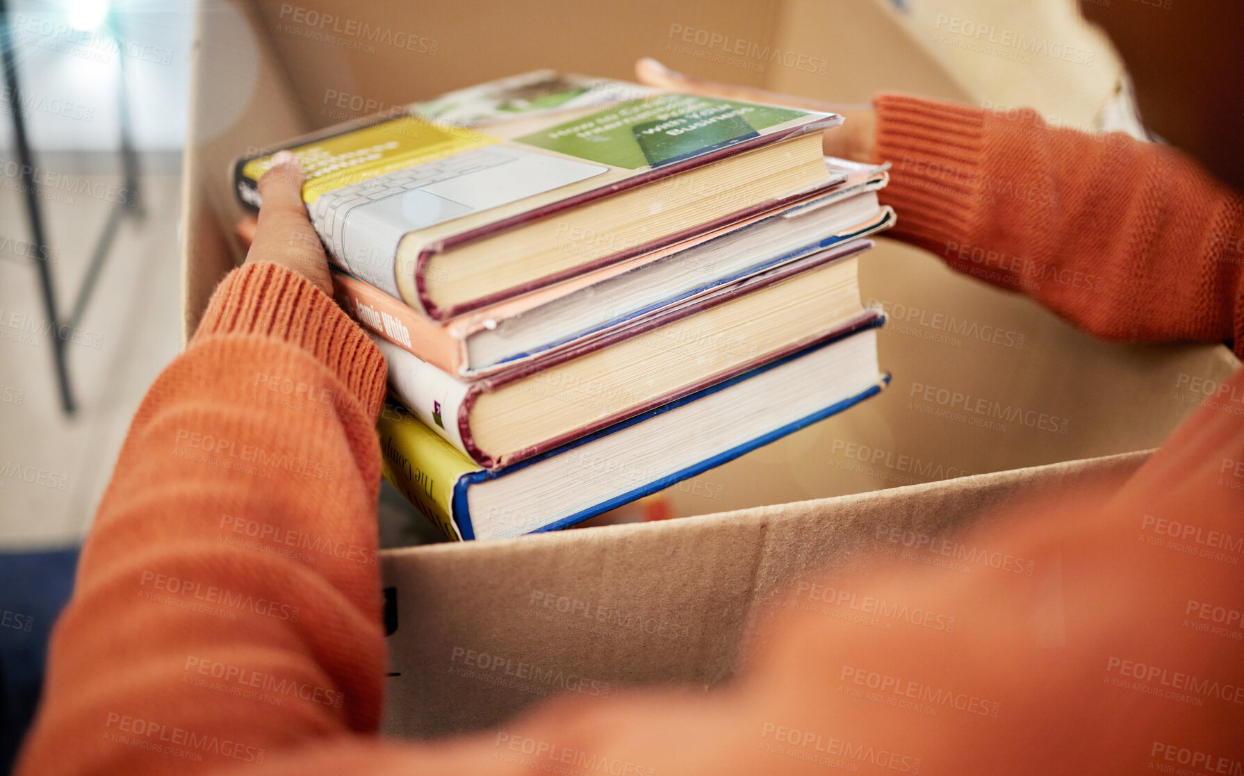 Buy stock photo Donation, charity and woman hands with books in box for nonprofit and cardboard container at home. Education textbook, donating and house with giveaway and spring cleaning for community support