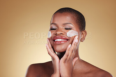 Buy stock photo Happy, skincare and black woman with face cream in studio for makeup removal and wellness on brown background. Facial, cleaning and model with moisturizer, exfoliate or beauty, dermatology or mask