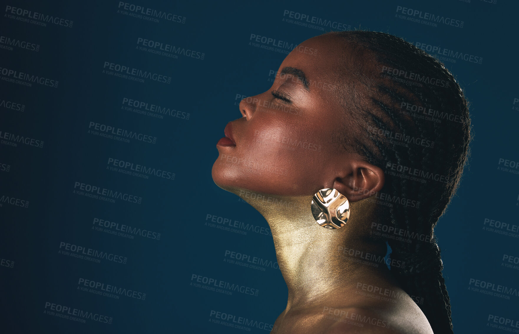 Buy stock photo Profile, beauty and black woman in gold for culture, heritage or tradition on a blue background in studio. Face, mockup and african style with a young model closeup for elegance or cosmetics