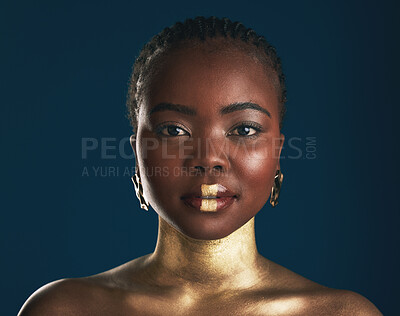 Buy stock photo Gold makeup, studio portrait or black woman with creative art, facial cosmetics paint and lipstick. African culture, face glow and person with beauty design, wellness or creativity on blue background