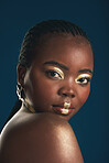 Gold makeup, portrait and black woman confident with creative art, facial cosmetics paint and beauty design. African culture, studio or female model with face glow, shine or unique on blue background
