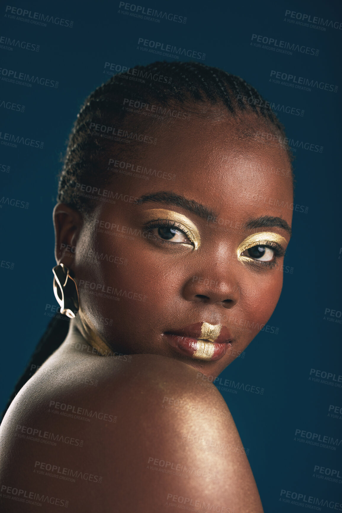 Buy stock photo Gold makeup, portrait and black woman confident with creative art, facial cosmetics paint and beauty design. African culture, studio or female model with face glow, shine or unique on blue background