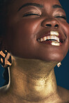 Smile, gold and makeup with face of black woman in studio for creative, luxury and cosmetics. Glow, glamour art and beauty with model on dark background for elegant, skincare and salon treatment