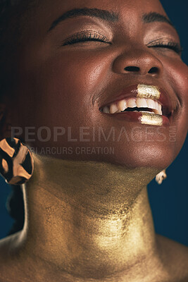 Buy stock photo Smile, gold and makeup with face of black woman in studio for creative, luxury and cosmetics. Glow, glamour art and beauty with model on dark background for elegant, skincare and salon treatment